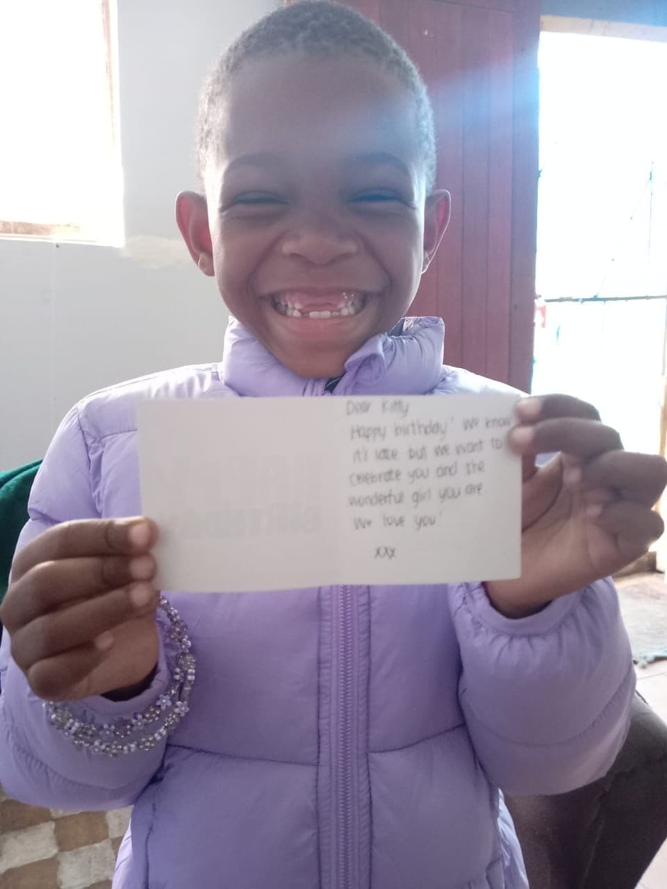Iyazi wearing her new jacket and bracelet and showing off her birthday card